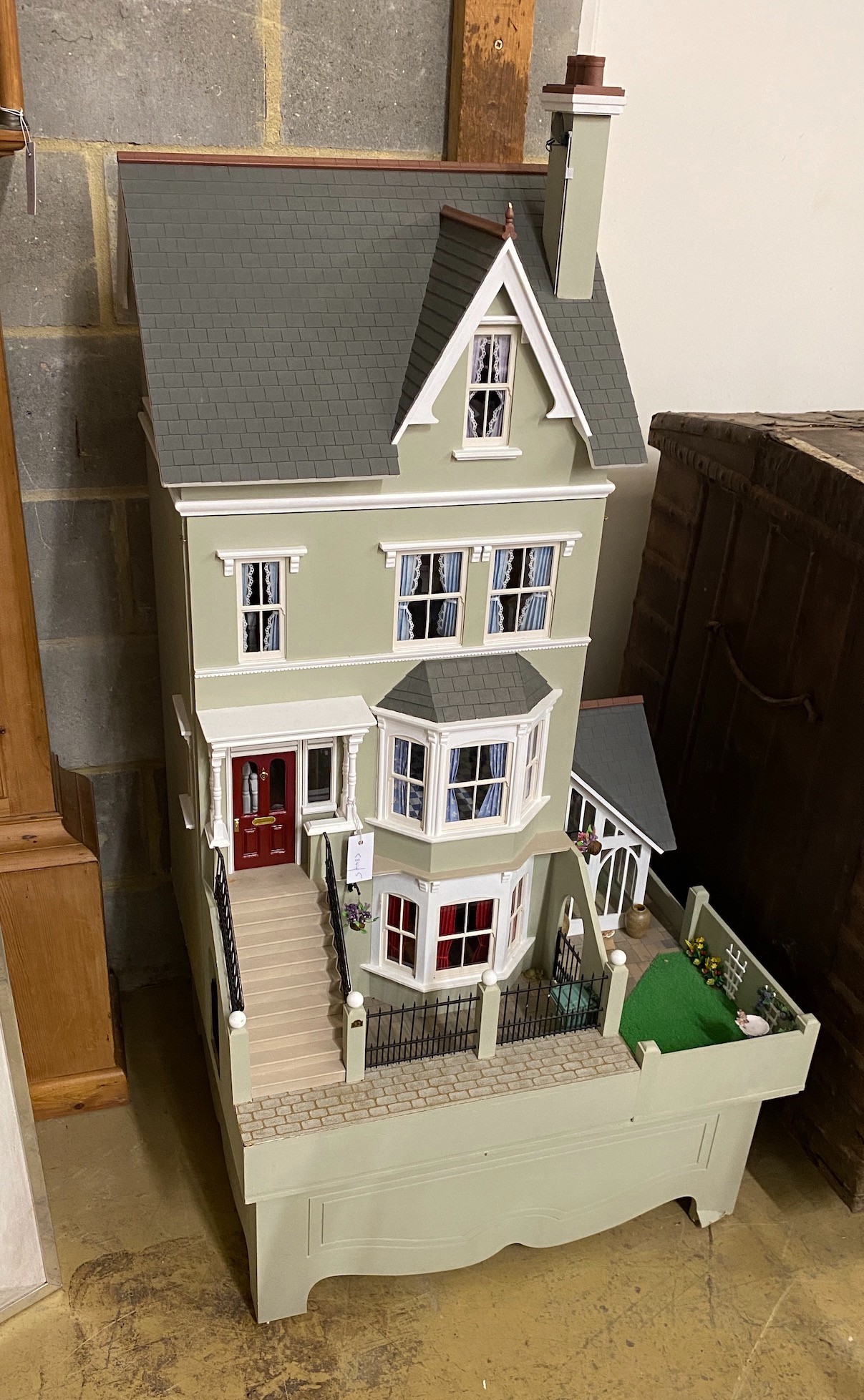 A good quality modern painted wood doll's house, modelled as a Victorian four storey villa, width 76cm, depth 73cm, height 150cm